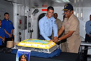 US Navy 091008-N-9761H-041 Vice Adm. D.C. Curtis and Intelligence Specialist 3rd Class Ryan Paigo cut a cake during a ceremony in observance of Hispanic American Heritage Month