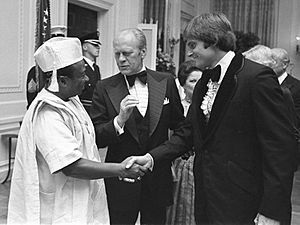 Bruce Jenner greets Gerald Ford and William Tolbert in 1976 (cropped)