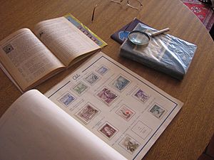 Chilean stamp album and catalogue, and a magnifying glass