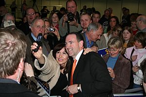 Former Arkansas Governor and 2008 Republican presidential candidate Mike Huckabee with a supporter at a campaign rally in Wisconsin