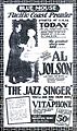 Advertisement from the Blue Mouse Theater announcing the Pacific Coast premiere of The Jazz Singer, billed as "The greatest story ever told". A photo of stars Al Jolson and May McAvoy accompanies extensive promotional text, including the catchphrase "You'll see and hear him on Vitaphone as you've never seen or heard before". At the bottom is an announcement of an accompanying newsreel.