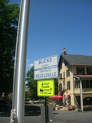 Signs on the approach for the Riegelsville Bridge denoting entrance into Riegelsville. The Riegelsville Inn can be seen in the background.