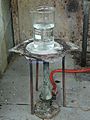 A laboratory heat spreader made of asbestos, over Teclu burner