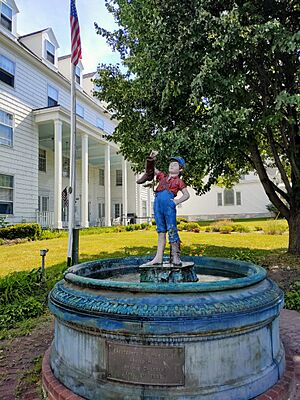 A statue of a young boy with a leaky boot
