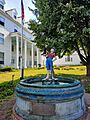 A statue of a young boy with a leaky boot