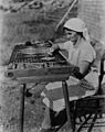 Acadian lady making rug 1938