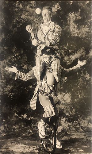 Skeeter Reece carrying Albert Alter juggling while on unicycle