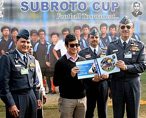 The Vice Chief of Air Staff, Air Marshal K.K. Nohwar releasing the souvenir of 52nd edition of the Subroto Cup Football Tournament and presenting the first copy to Shri Baichung Bhutia