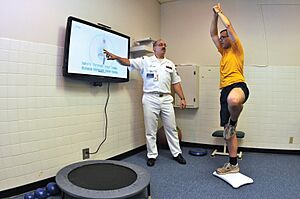US Navy 090702-N-1783P-003 Hospital Corpsman 1st Class Guy Duke, left, and Electronics Technician 3rd Class Joshua Benedict demonstrate how the Physical therapy Department at Naval Health Clinic, Charleston use the Wii Fit's yoga