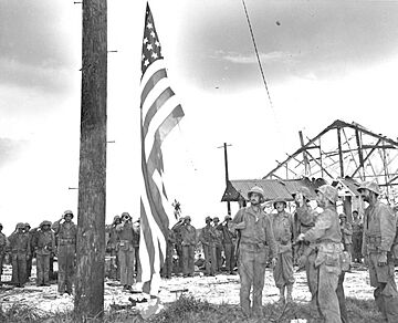 440721-O-BC209-004 Marines raise the American Flag over the Marine barracks on the island of Guam
