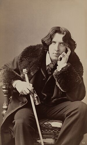 Oscar Wilde by Napoleon Sarony. Three-quarter-length photograph, seated