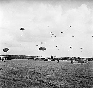 Paratroops gathering their parachutes