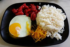 Pork tocino with eggs, rice, and atchara (typical Filipino breakfast)