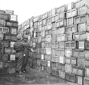 A stack of ration boxes being checked at an Army Dump