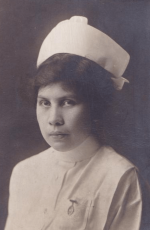 A young Oneida woman wearing a white nurse's cap and uniform
