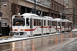 Denver LRVs in snow, on Stout St in downtown