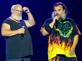 Two men with microphones on stage