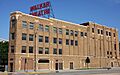 Flatiron-shaped brick building with "Walker Theatre" in large red letters