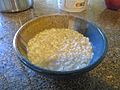 Cooked oatmeal in bowl (low angle)