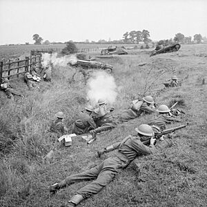 Home Guard troops 'fighting' Valentine tanks of 6th Armoured Division during large-scale manoeuvres at Yelden in Bedfordshire, 27 July 1941. H12081