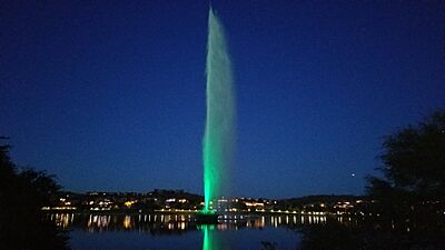 The fountain is bathed in green in Fountain Park with LED lights during holidays and special events. There are eight colors available to shine on the spray.