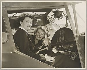 Australian Women Pilots' Association Air Reliability Trial entrants Meg Cornwell (left) and Margaret Sincotts in the cockpit of an Auster J-4 Archer monoplane on the tarmac at an airfield, 1953 (16289750475)
