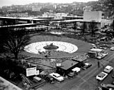 International Fountain, a large public water fountain, shown under construction in Seattle in 1962. The fountain was one of the centerpieces of the Century 21 Exposition, held in Seattle in 1962. In the photograph, the white rocks surrounding the center of the fountain have not been fully installed.
