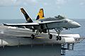 An F-A-18C Hornet launches from the flight deck of the conventionally powered aircraft carrier