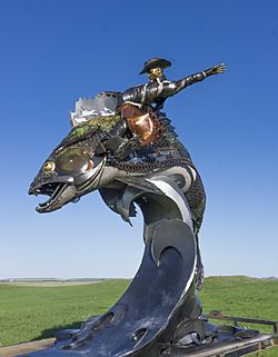 Scrap metal sculpture of a cowboy riding a walleye on the south end of main street in Mobridge