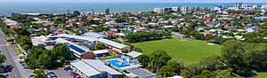 Aerial view of Scarborough State School with Moreton Bay in the distance, 2023