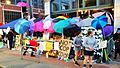 Outdoor market, protected by colorful umbrellas
