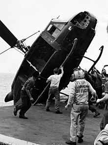 South Vietnamese helicopter is pushed over the side of the USS Okinawa during Operation Frequent Wind, April 1975.jpg