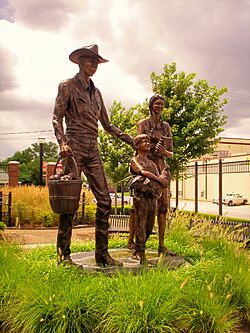 Statue of an early 20th-century family, in Centennial Park on Main Street