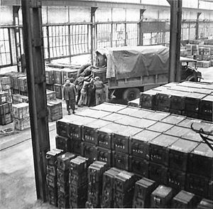 Ammunition being stacked in the ordnance store at Second Army Roadhead