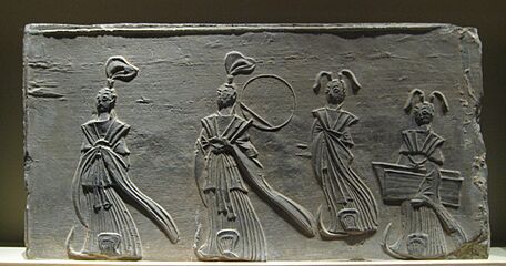 Brick relief of two scholars and two maids