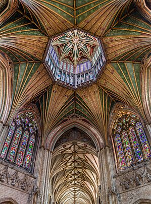 The interior view from beneath an octagonal wooden tower with star shaped vaulting and big windows.