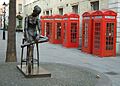 Red telephone boxes behind Young Dancer - Broad Street - London - 240404