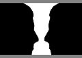 Two silhouette profile or a white vase