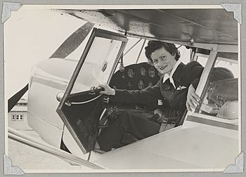 Australian Women Pilots' Association member Meg Cornwell in the cockpit of Auster J-5G Cirrus Autocar monoplane VH-ADY at an airfield, 1954 (16103886047)