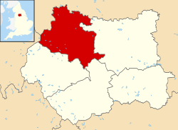A map of England coloured pink showing the administrative subdivisions of the country. The Leeds metropolitan borough area is coloured red.