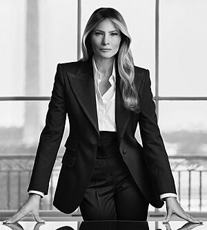 Official portrait of Melania Trump, a middle-aged white woman with long dark hair, wearing a black suit.