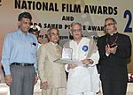 Pranab Mukherjee presenting the Dadasaheb Phalke Award 2013 to Shri Gulzar, the veteran film lyricist, director, screen writer, producer and poet, at the 61st National Film Awards Function.jpg