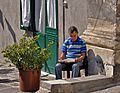 Reading a newspaper. Catania, Italy