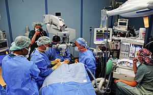 US Navy 080607-N-9689V-008 Cmdr. Kenneth Kubis and U.S. Air Force Capt. Tighe Richardson use an operating microscope while performing cataract eye surgery to return sight to Marylin Kansi, a 12-year-old girl from Cotabato.jpg