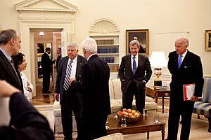 Barack Obama talks in the background with Sen. Charles Grassley, 2009