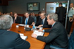 US Navy 030325-D-9880W-046 The Honorable Donald H. Rumsfeld, Secretary of Defense (2nd from right), introduces President George W. Bush (right) to participants at a briefing held in the Pentagon