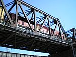 A steel truss bridge with a locomotive on it.