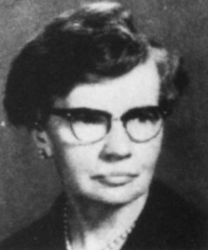 A white woman with short greying hair, wearing glasses