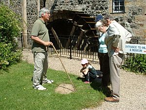 Dalgarven Mill Waterwheel and members of the public at a Guided Tour