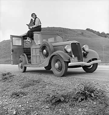 Dorothea Lange atop automobile in California (restored)